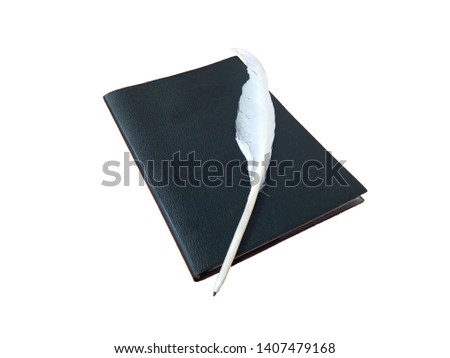 The feather pen is placed on a black book, white background concept