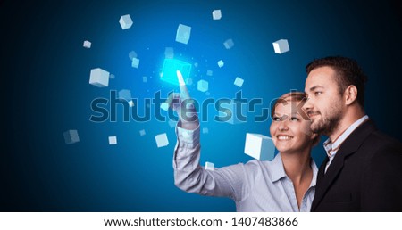 Man and woman touching hologram screen displaying cube symbols
