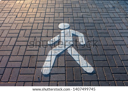 Pedestrian sign on the pavement in summer