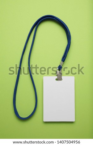 Security badge, lanyard plastic clip, template on green background.