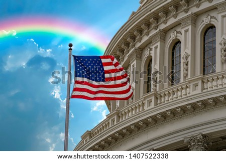 Washington DC Capitol with waving flag on rainbow after rain day