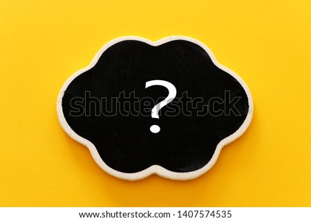 Chalkboard with question mark sign over yellow background