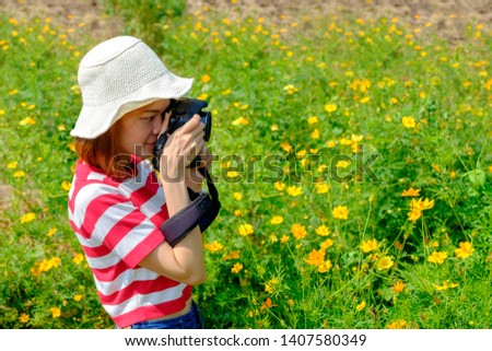 Asian woman Photographer travel at the flower garden