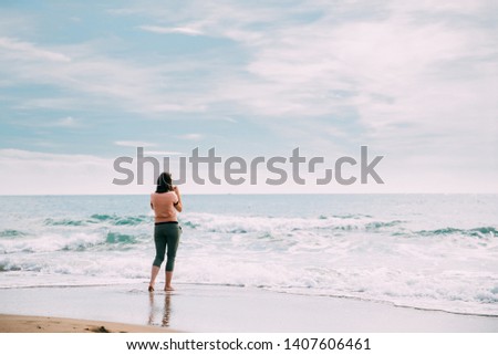 Young Caucasian Lady Woman Standing On Summer Sea Ocean Beach And Taking Photos On Smartphone.
