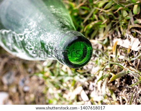 Throat old green bottle in nature .