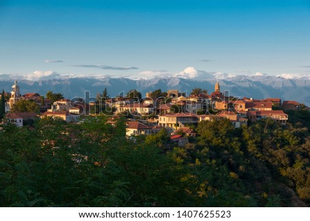 Panoramic view of Sighnaghi in winery region of Georgia, Kakheti, during sunset in summer with Caucasus mountains in the background