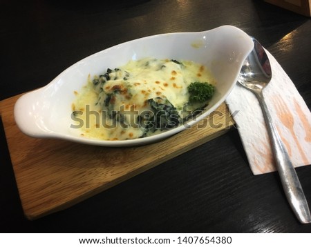 Baked spinach with hot cheese and spoon
