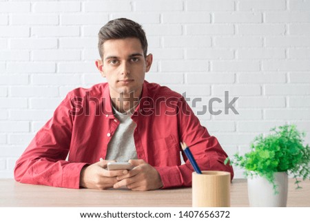 portrait of young man or student with mobile phone