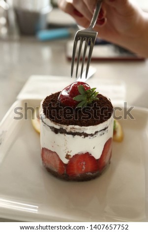 Closeup of woman eating cake in a cafe