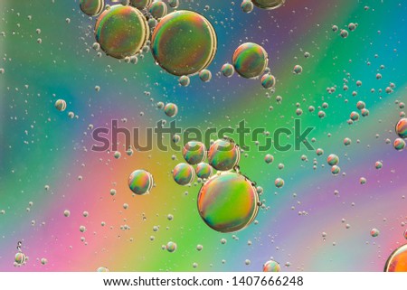 Psychedelic abstract background formed by oil droplets floating on water