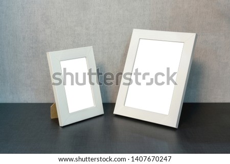 big and small empty white frame for a picture and a photo on the shelf, mock-up