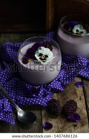 mousse with white chocolate and blackberry on a dark background