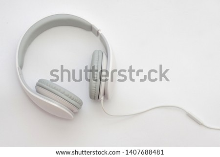 White headphones isolated, on white background. Royalty-Free Stock Photo #1407688481