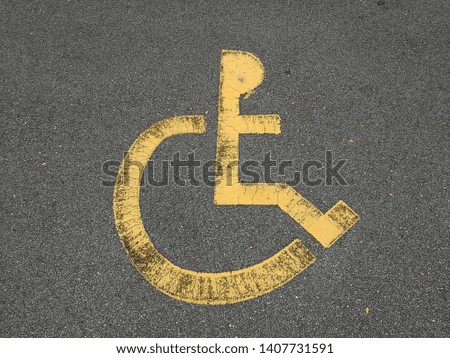 International markings for a handicapped parking, Disabled symbol sign on asphalt in parking space