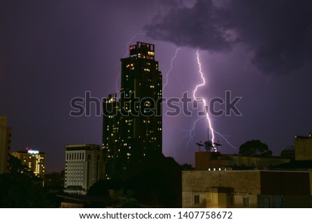 Building night city was thunderclap, hit of lightning, strike of lightning storm thunder on dark sky.  Royalty-Free Stock Photo #1407758672