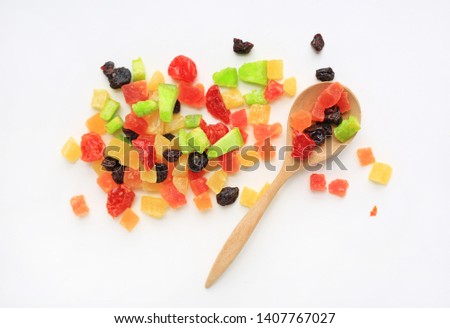 Dried fruits mix isolated on white background with wooden spoon. Top view.