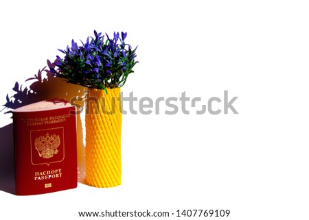 The concept of travel from Russia to Europe, including the memory of France. Artificial lavender bouquet and Russian passport close-up. On a white background. Copyspace.