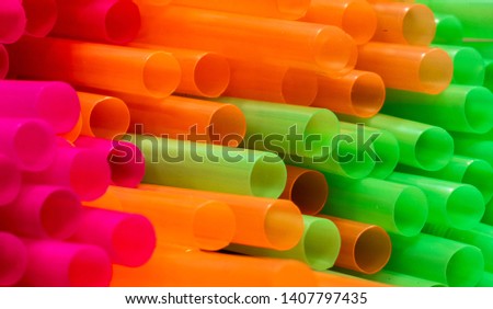 A close up shot of colored straws. The straws are used to drink drinks without putting your mouth to the glass. The plastic they are made of does cause environmental pollution