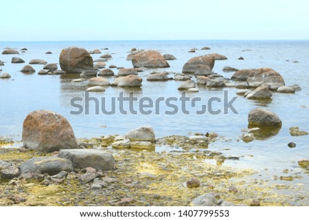 landscape with sea, blue sky and stones