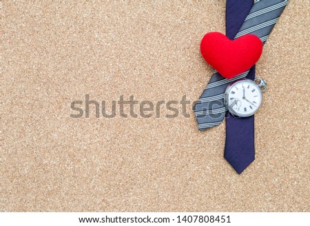 Red heart on men deisgn necktie with vintage watch on brown texture backgrond, Father's day card idea background