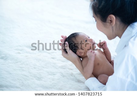 Newborn baby peacefully sleeping
Portrait of newborn hold at mother hands, family, healthy birth concept, selective focus