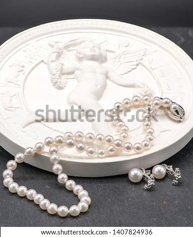 Amazing jewelry with beautiful pearl on a black background, luxury photo