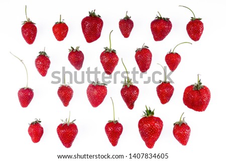 A lot of individual strawberries are isolated on a white background.