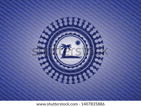 beach icon inside emblem with denim texture