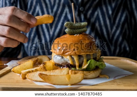fast food and unhealthy eating concept - fast food snacks on wooden table