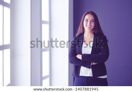 Modern business woman standing in the office .
