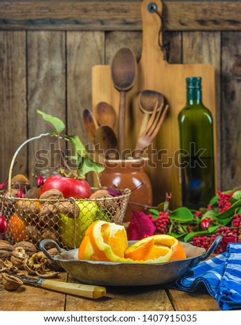 Kitchen still life: vintage utensils and ripe fruits, nuts on the rustic wooden background. Vertical picture, soft focus, selective focus