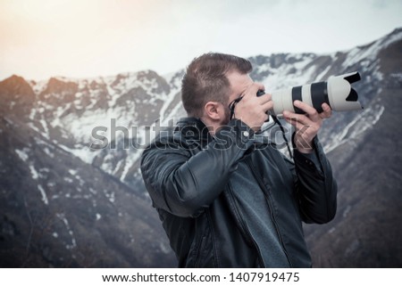 High end camera user. Camera operator. Photographing the photographer. - Image