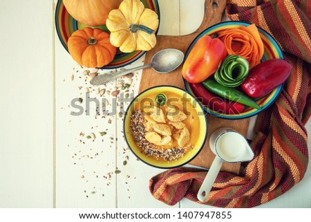 Healthy vegetarian seasonal Fall food cooking background. Flat-lay of Autumn vegetables and spice over wooden background, top view, copy space. Clean eating, alkaline diet food.