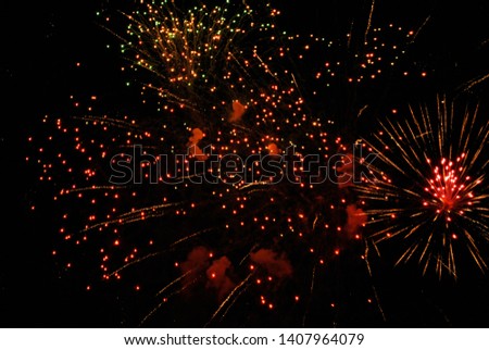 Colorful salute, great explodes in different colors in the night sky, beautifully dissolving in the air.