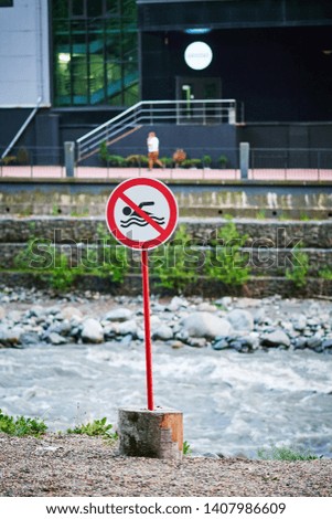 sign prohibiting swimming in the river