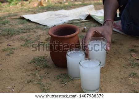 palm wine from date tree in clay pot and glasses India west Bengal