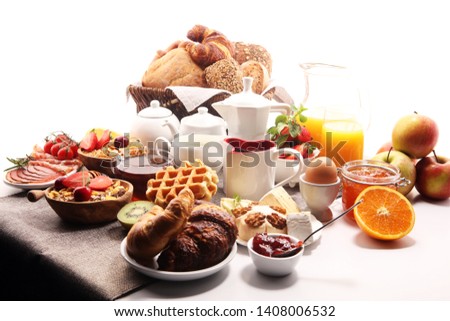 Huge healthy breakfast on table with coffee, orange juice, fruits, waffles and croissants. Cereals and balanced died. Good morning concept.