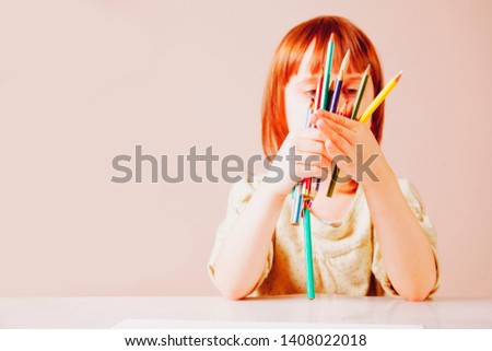 Great artist. Cute child girl drawing with color pencils