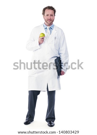 Full length of a doctor holding green apple and folder over white background