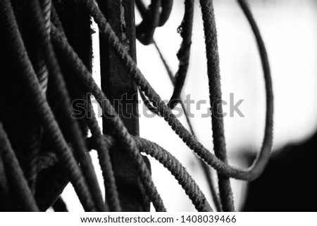 Used old rope in barn for roping in rodeo industry, black and white vintage style.