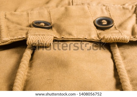 clothing items washed cotton fabric texture with seams, clasps, buttons and rivets