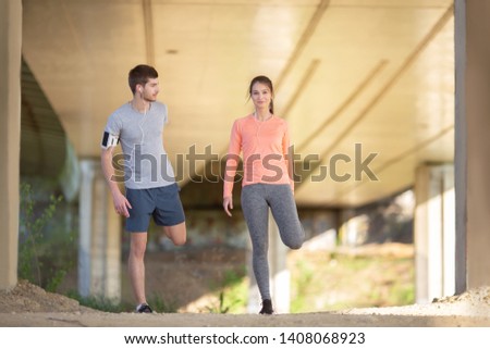 Young and beautiful couple stretching outdoors together 