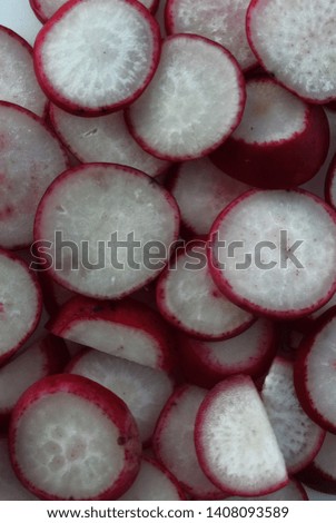 A picture of a background with sliced ​​radish pieces on a white background. Food photo. Top view.