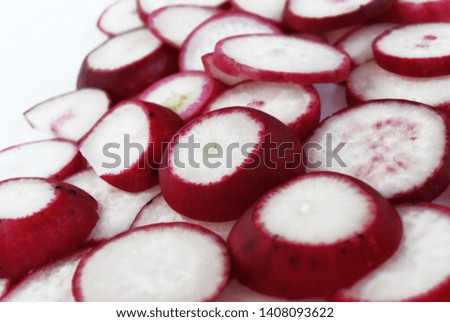 A picture of a background with sliced ​​radish pieces on a white background. Food photo