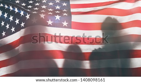 Patriotic holiday. Happy family, parents and child with American flag. USA celebrate 4th of July. 