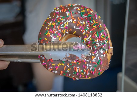 Large chocolate donuts with rainbow sprinkles