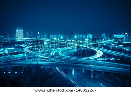 interchange in shanghai at night,clover stack type overpass with blue tone