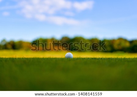 Bournemouth Queens Park Golf Course. Defocused golf ball on the grass field making ideal golfing sport themed advertising background. Stunning nature of Dorset Coast Colourful Sunset, England.        