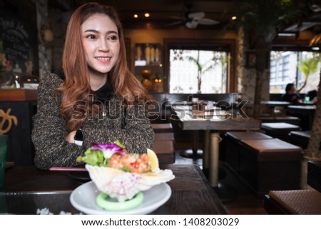 woman eating salmon sashimi spicy salad in the restaurant