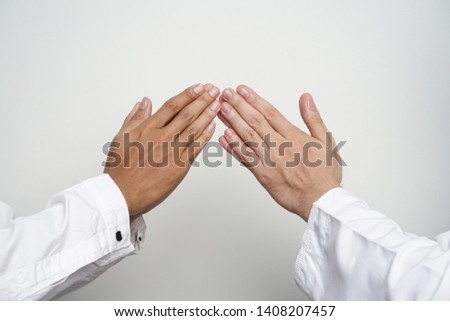 Close up gesture of hand finger tip touching. Islam muslim man greeting eid mubarak                   Royalty-Free Stock Photo #1408207457